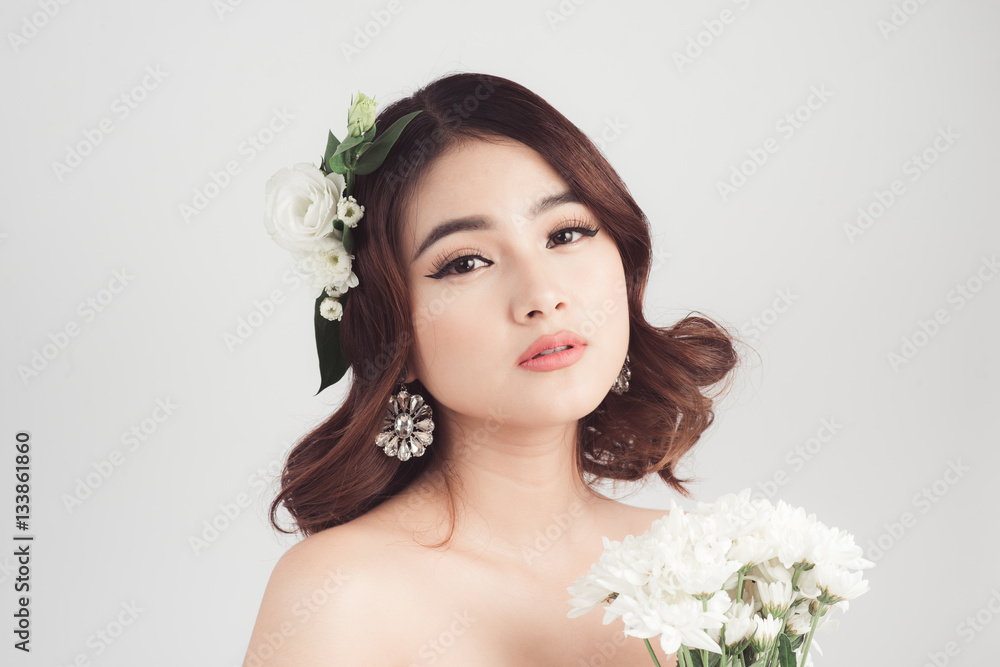 Beautiful asian woman bride on grey background. Closeup portrait