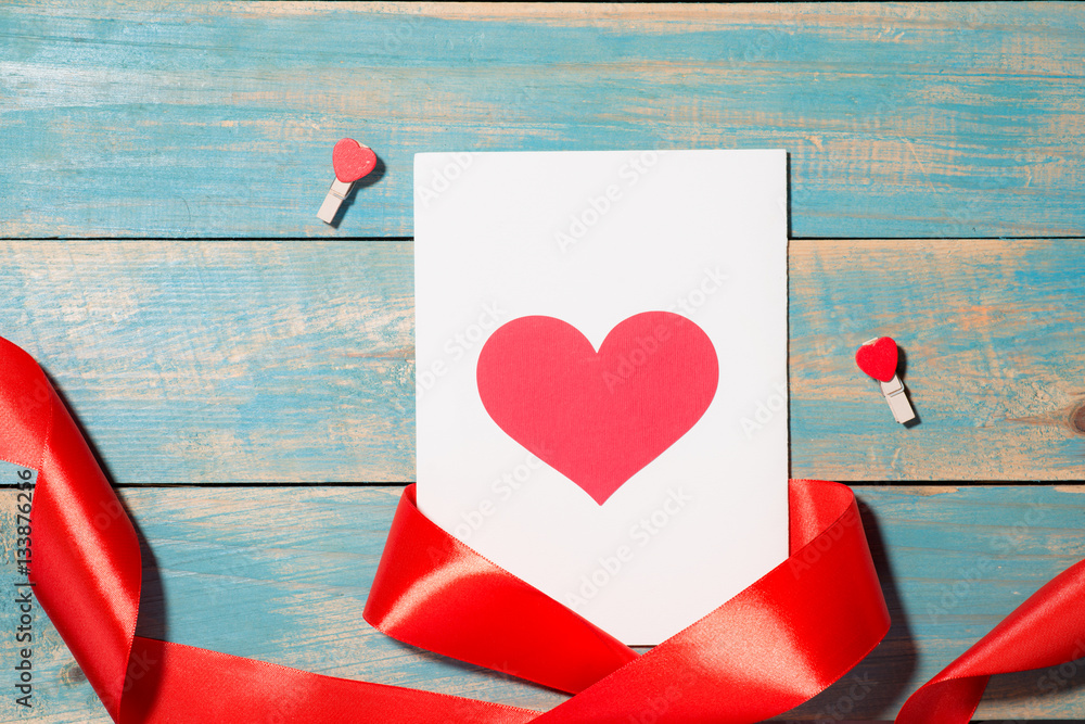 Valentines Day greeting card over wooden background. Top view w