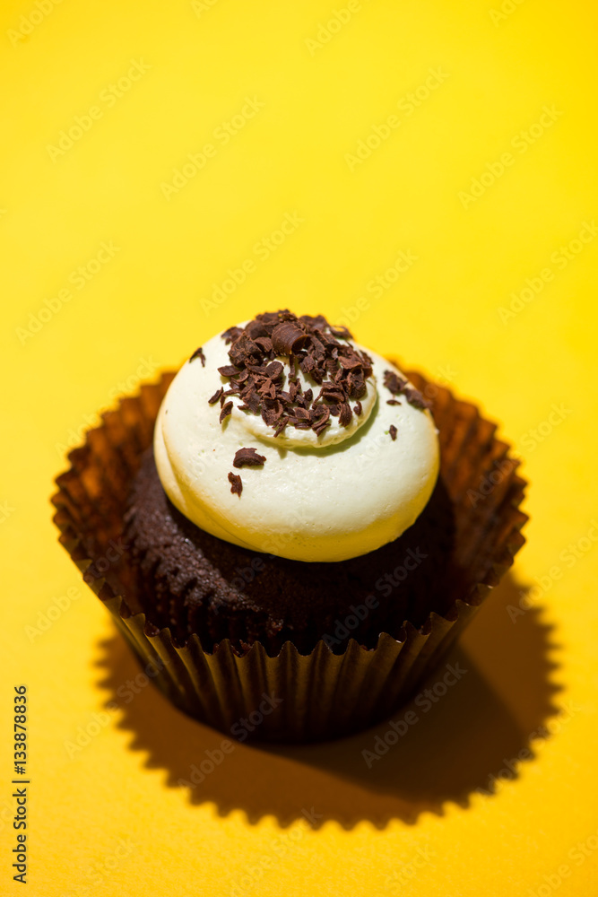 Birthday cupcake against a yellow background