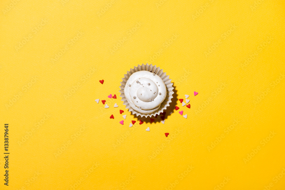 Birthday cupcake against a yellow background