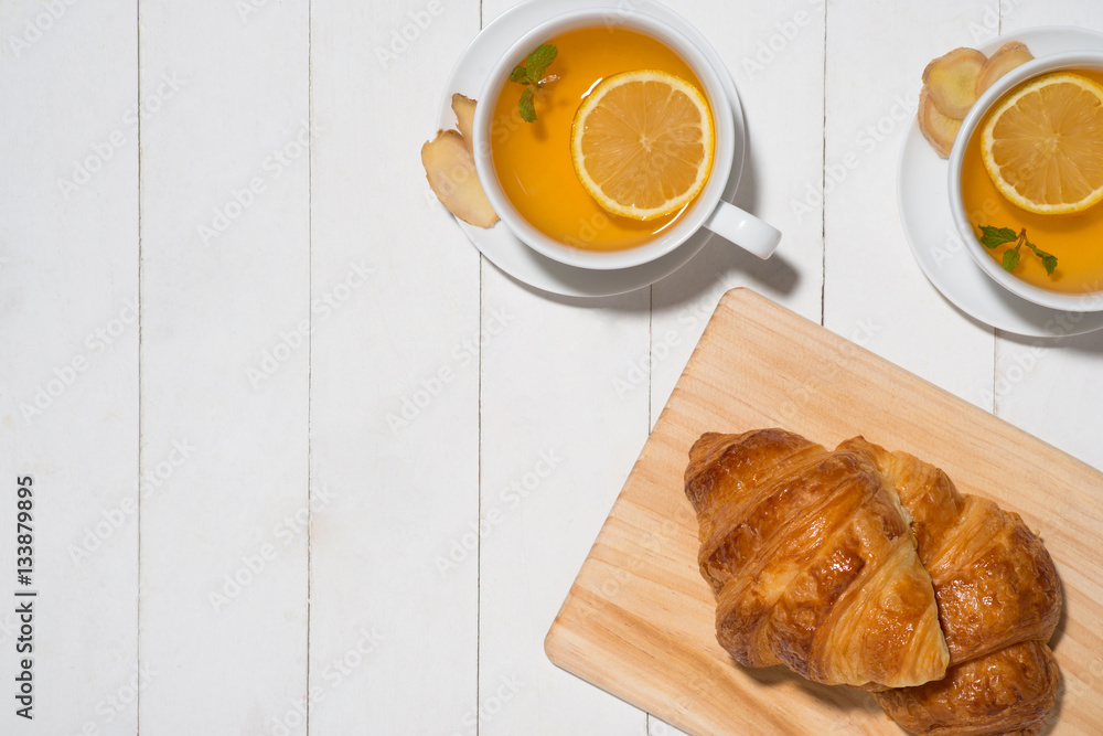 Healthy ginger tea with morning breakfast on a wooden table