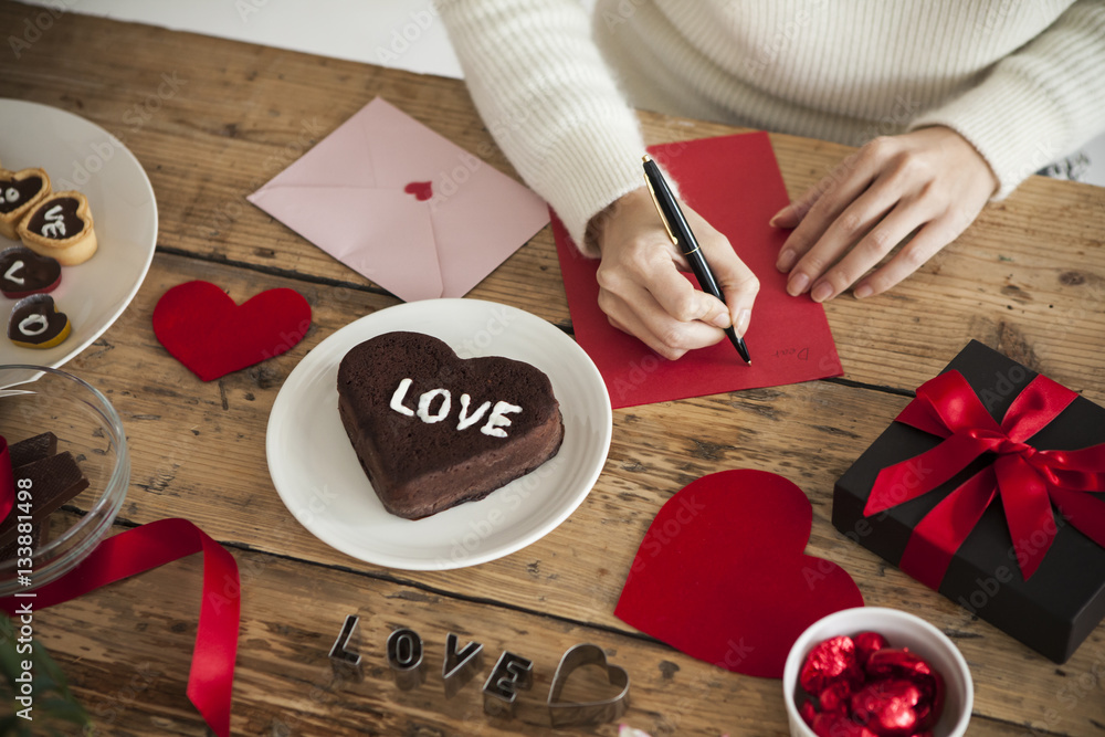 woman is writing a message of love