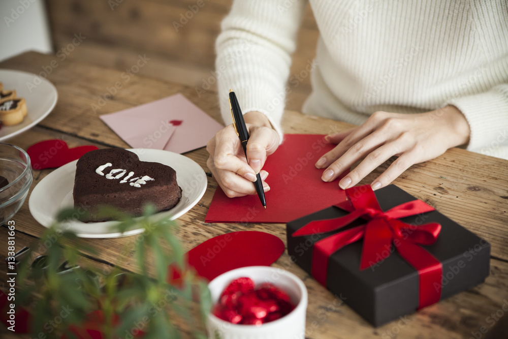 woman is writing a message of love