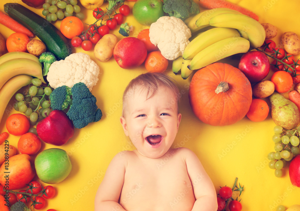 Baby surrounded with fruits and vegetables