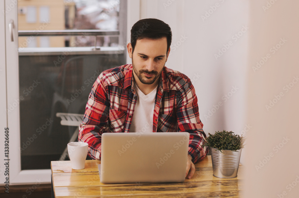 Handsome man working from his home office