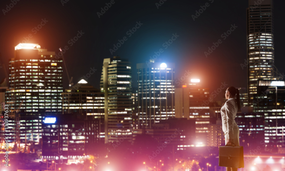 Woman looking at night city