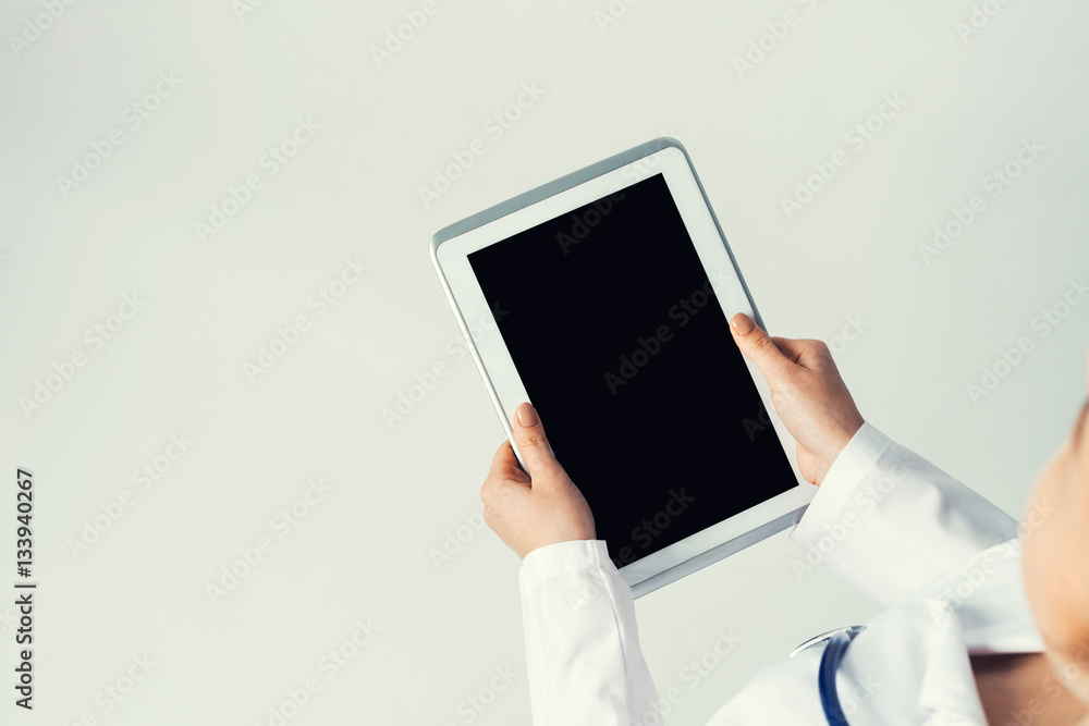 Close of female doctor hands working with tablet pc computer