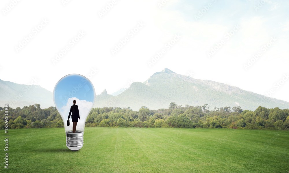 Businesswoman inside light bulb