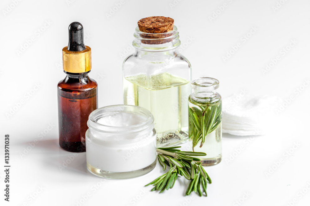 organic cosmetics with extracts of herbs rosemary on white background