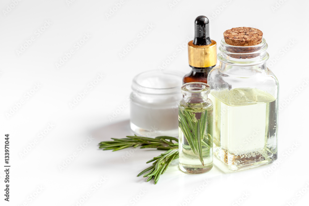 organic cosmetics with extracts of herbs rosemary on white background