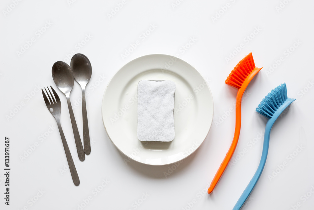 concept of washing dishes on white background top view