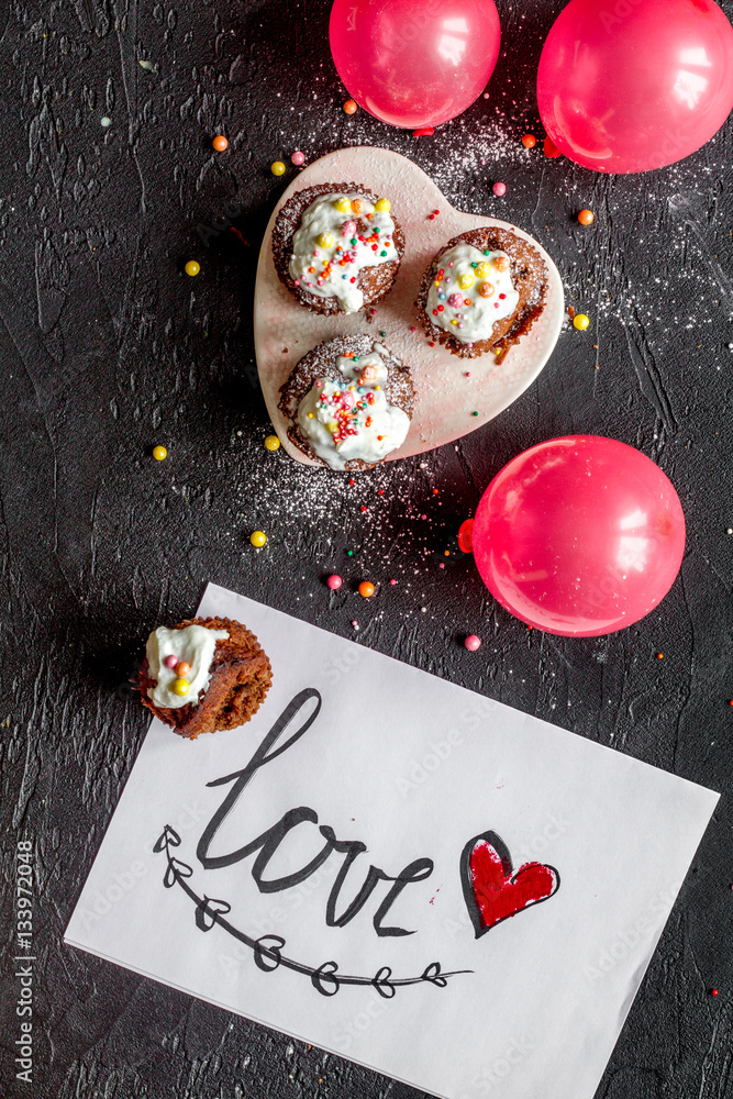 concept of Valentines Day cupcakes dark background top view