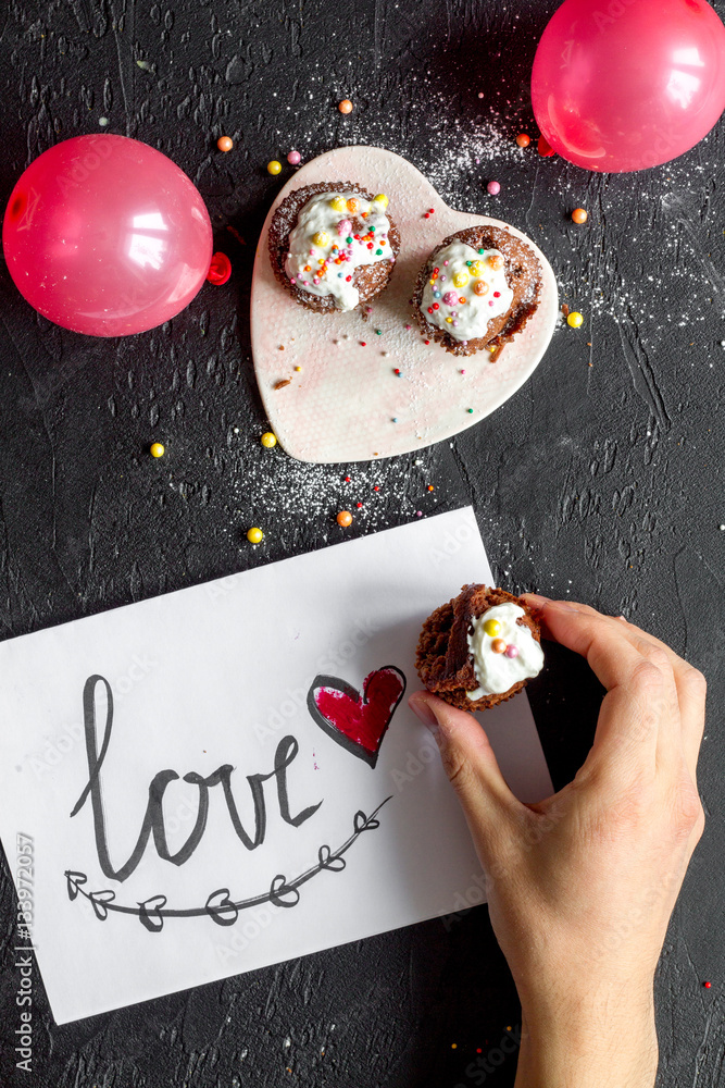 concept of Valentines Day cupcakes dark background top view