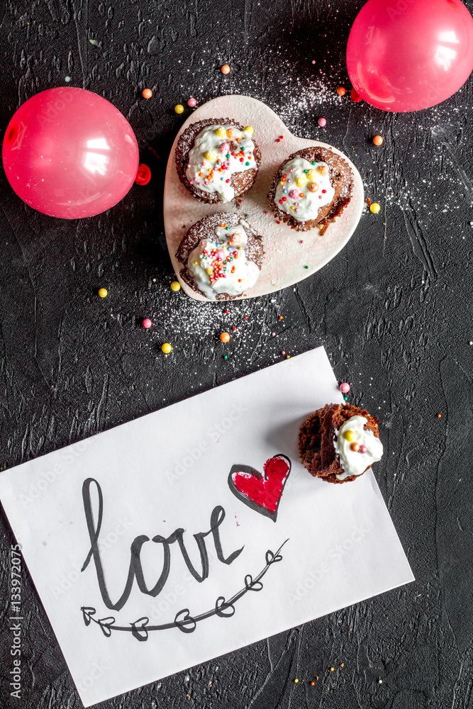 concept of Valentines Day cupcakes dark background top view