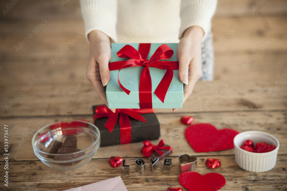 The woman gives chocolate to Valentines Day