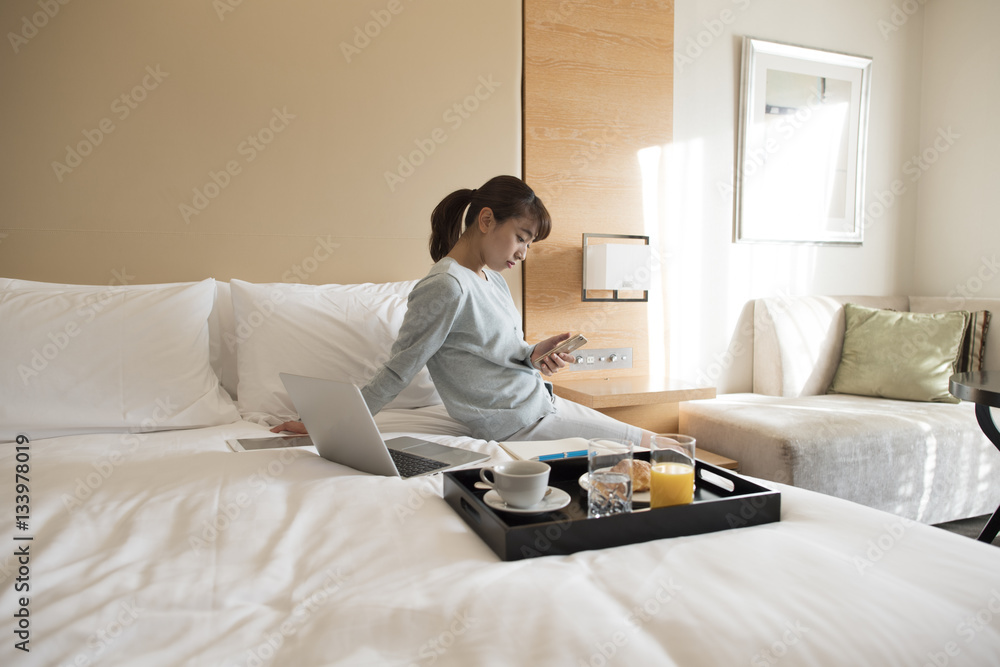 Women are crazy about smartphones in hotel rooms