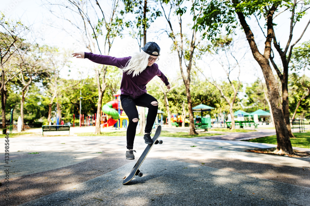 Young Woman Jumping Olly Skateboard Concept