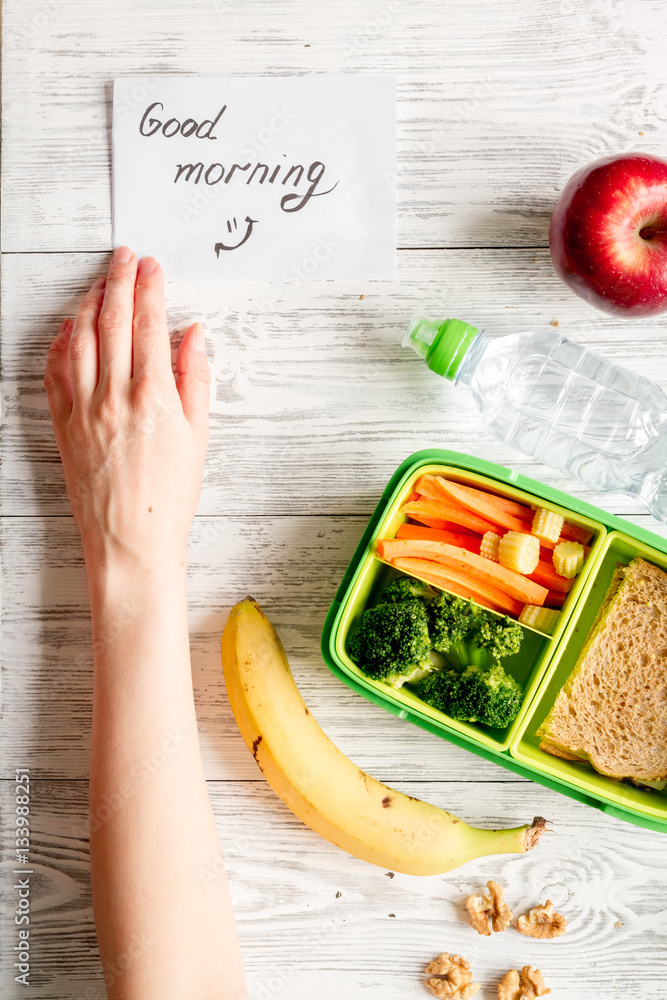 kid menu lunchbox for school top view on wooden background