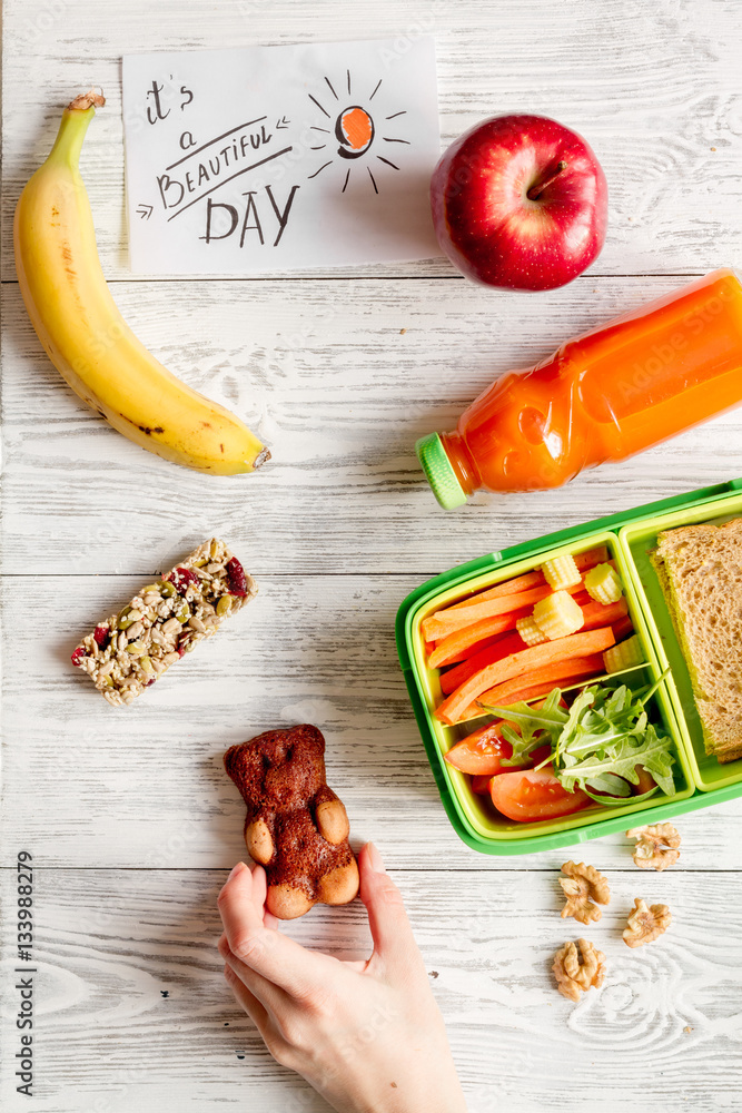 kid menu lunchbox for school top view on wooden background