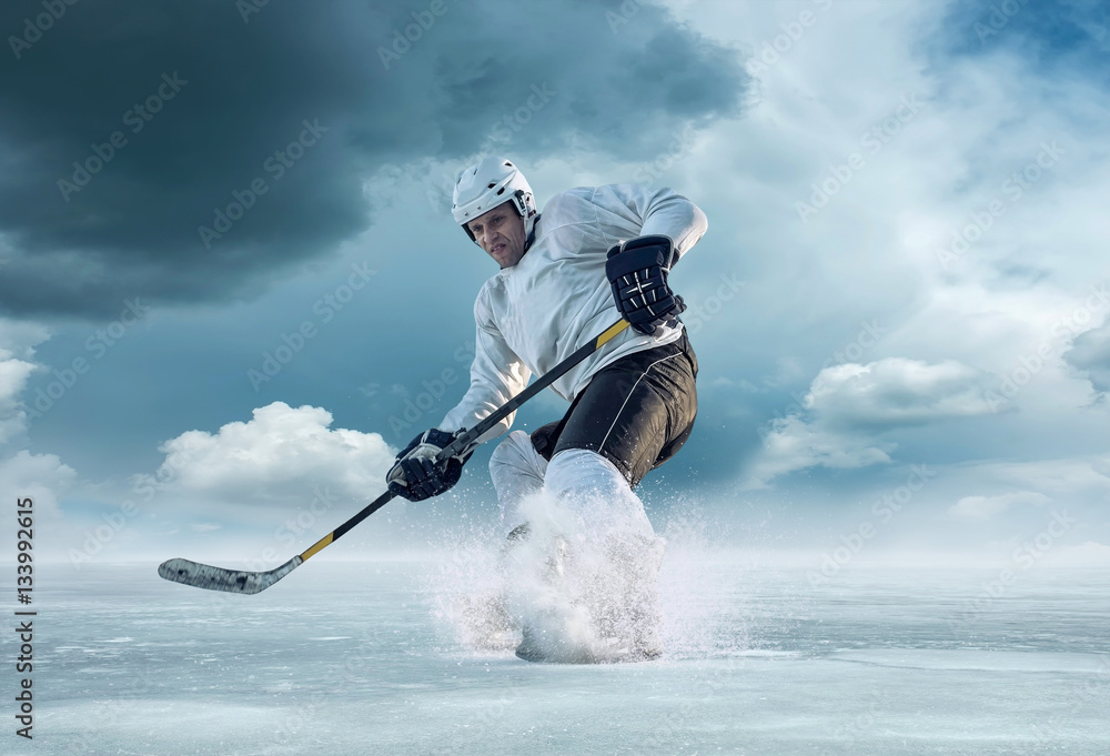 Ice hockey player in action outdoor around mountains