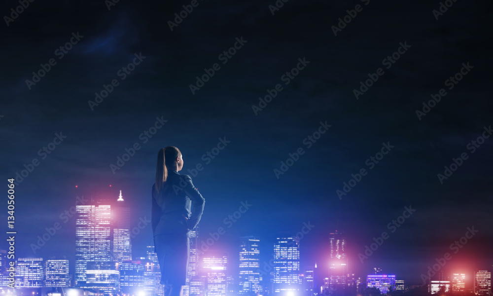 Woman looking at night city