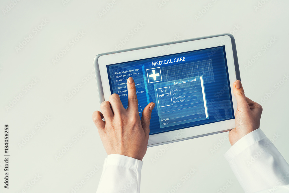 Close of female doctor hands working with tablet pc computer