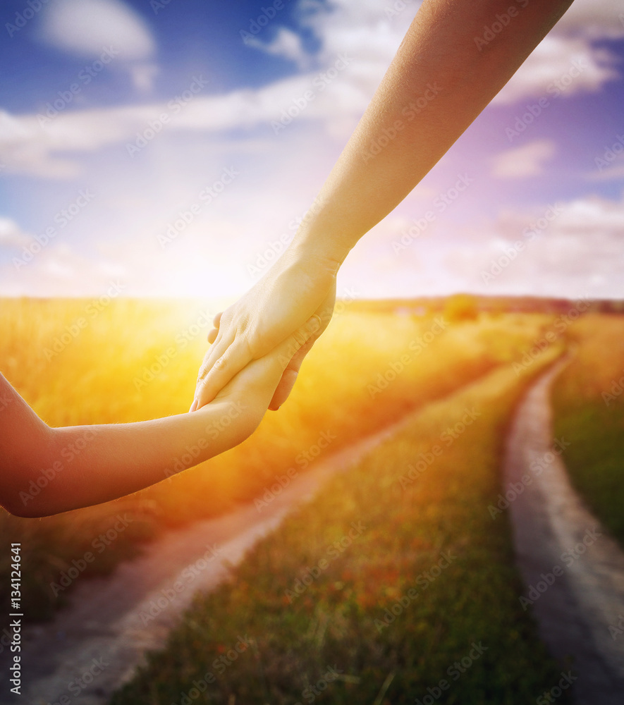 Hands of mother and daughter