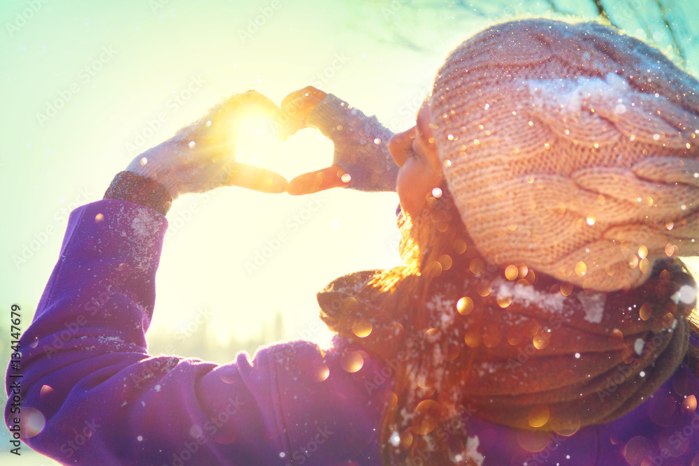 Valentines Day. Beauty joyful teenage model girl having fun in winter park. Winter girl showing Val