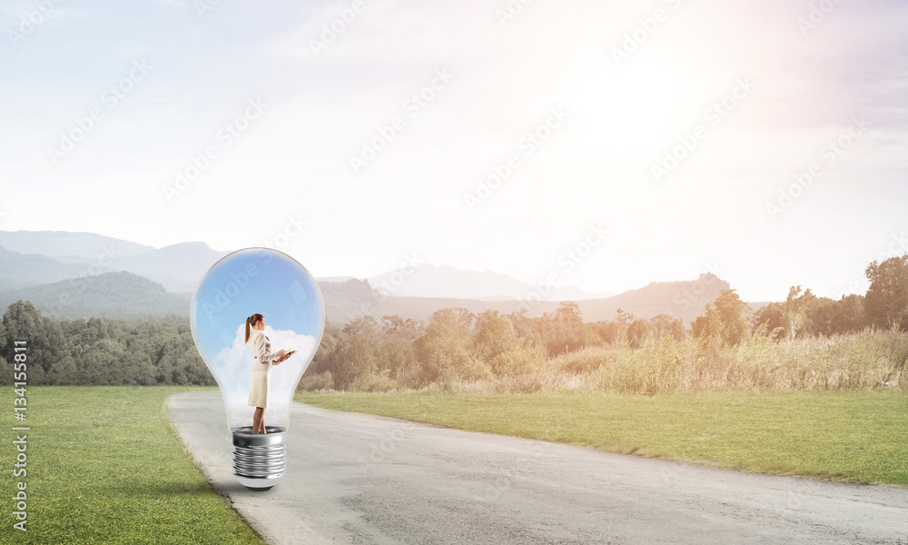 Businesswoman inside light bulb