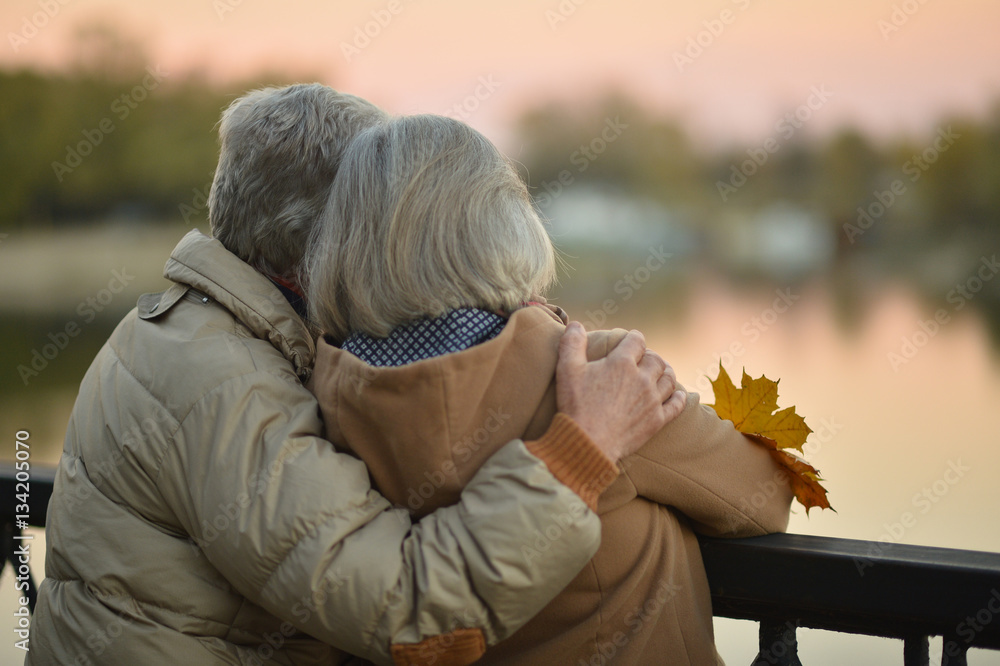 Happy senior couple  near river