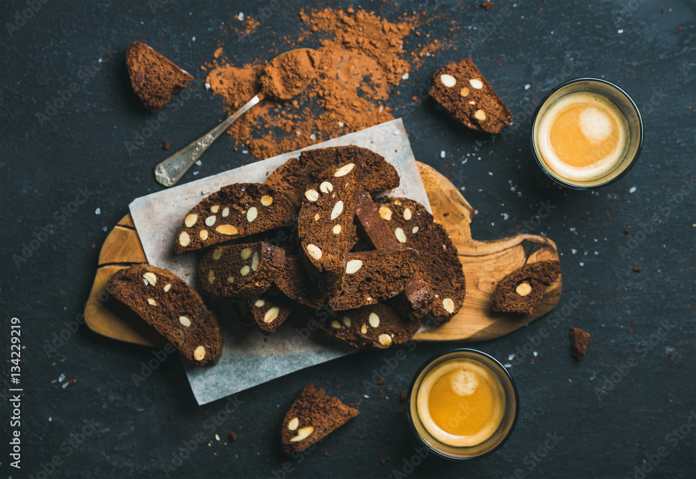 Dark chocolate and sea salt Biscotti with almonds and two glasses of coffee espresso on wooden servi