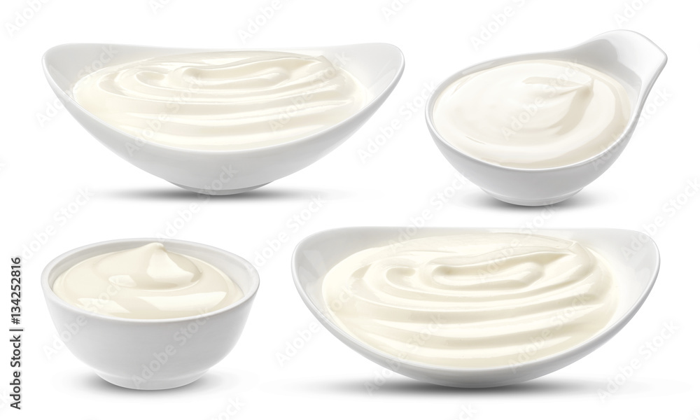 Bowl of sour cream isolated on white