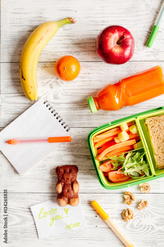 kid menu lunchbox for school top view on wooden background