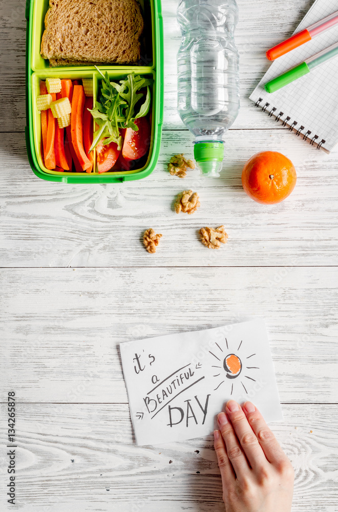 kid menu lunchbox for school top view on wooden background