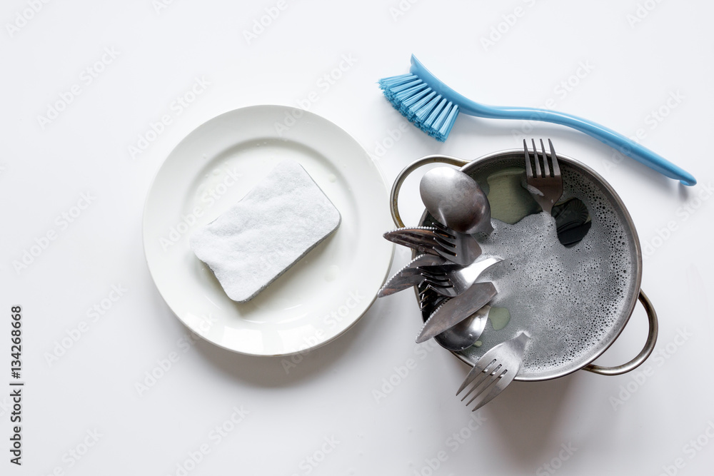 concept of washing dishes on white background top view