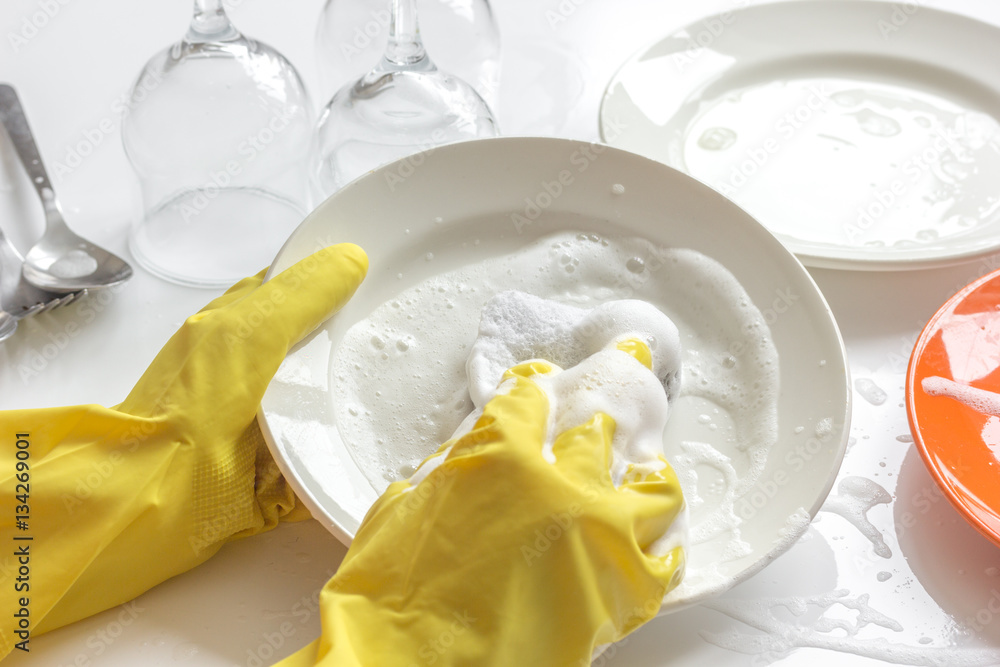 concept of woman washing dishes on white background