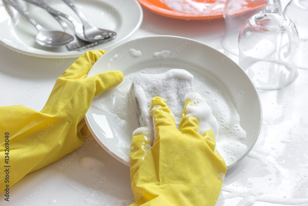 concept of woman washing dishes on white background