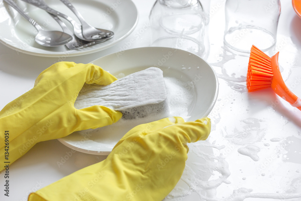 concept of woman washing dishes on white background