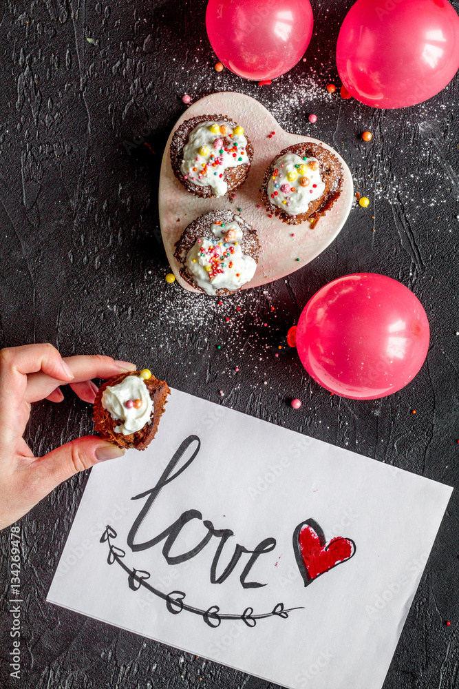 concept of Valentines Day cupcakes dark background top view