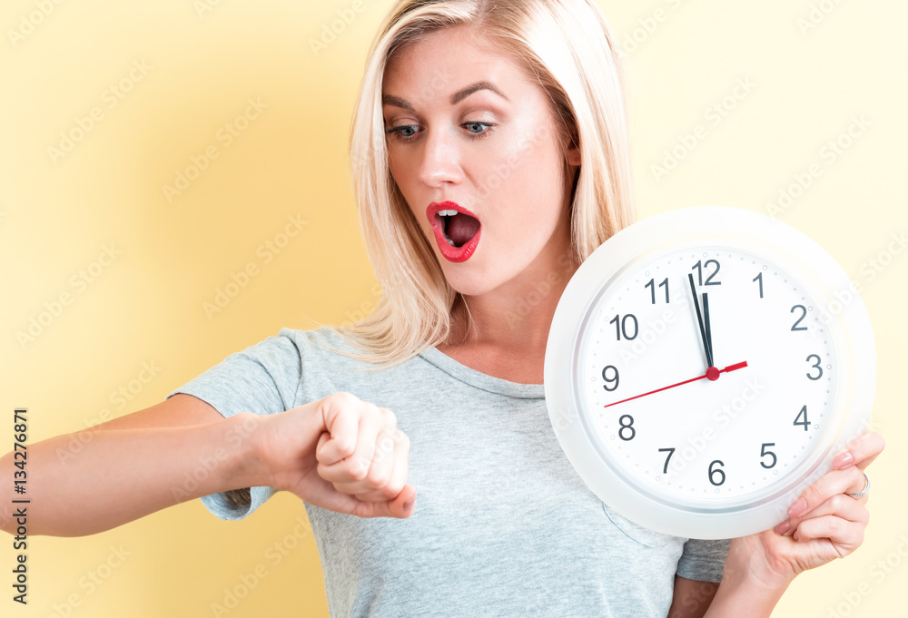  Woman holding clock showing nearly 12