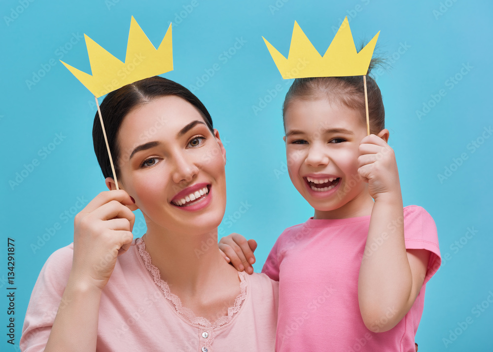 Mom and child are holding crown