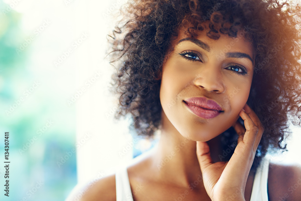 Portrait of smiling young black woman in sunshine