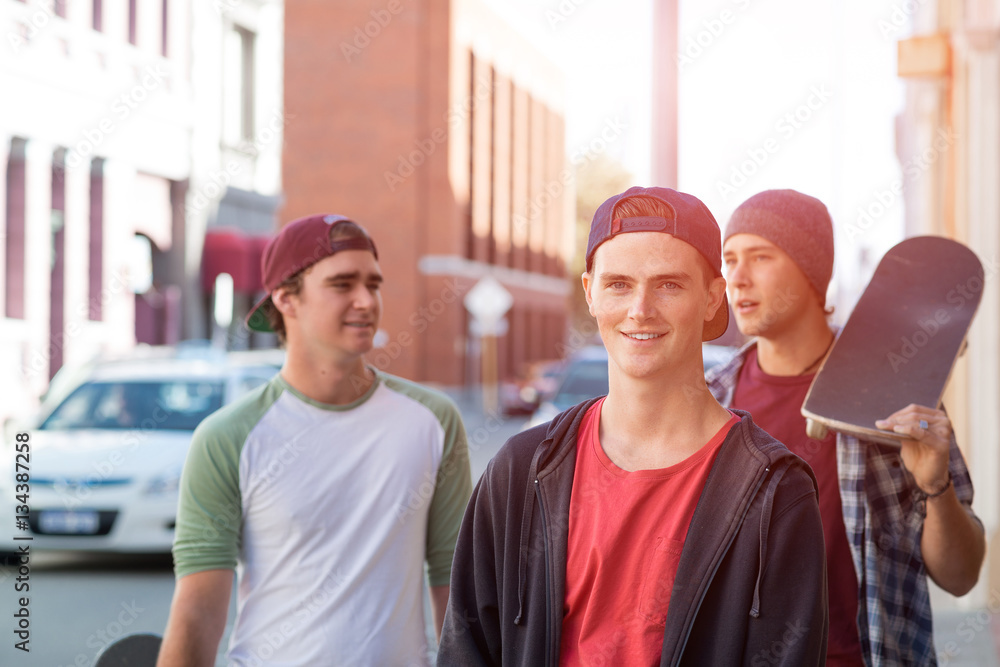 Guys skateboarders in street