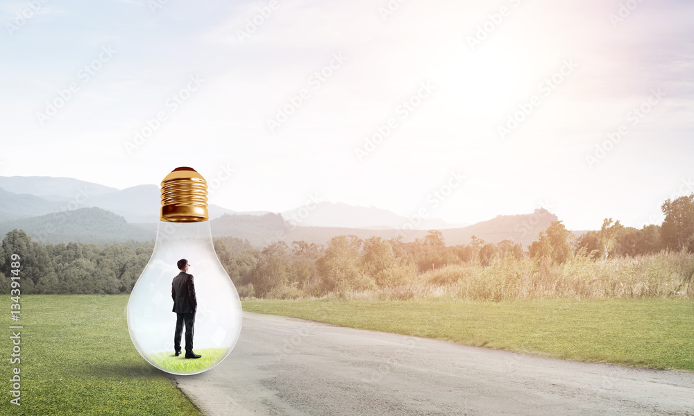 Businessman inside light bulb