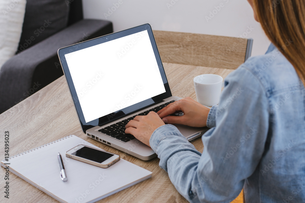 Woman typing on notebook with blank screen with copy space