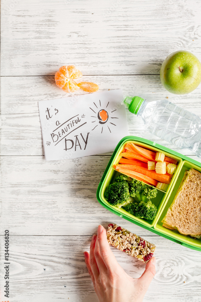 kid menu lunchbox for school top view on wooden background