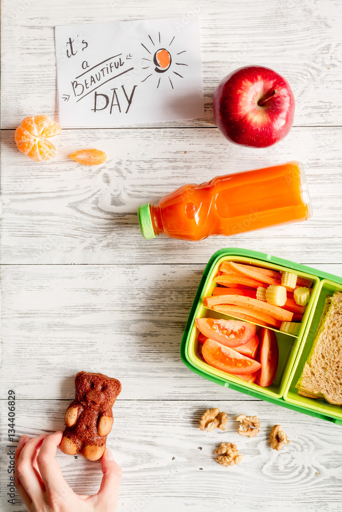 kid menu lunchbox for school top view on wooden background