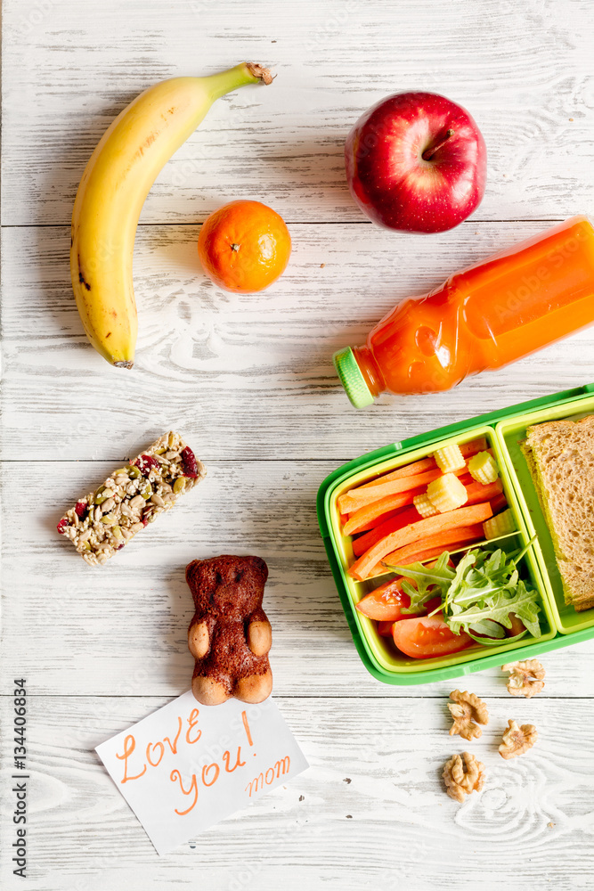 kid menu lunchbox for school top view on wooden background