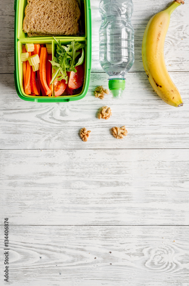 kid menu lunchbox for school top view on wooden background