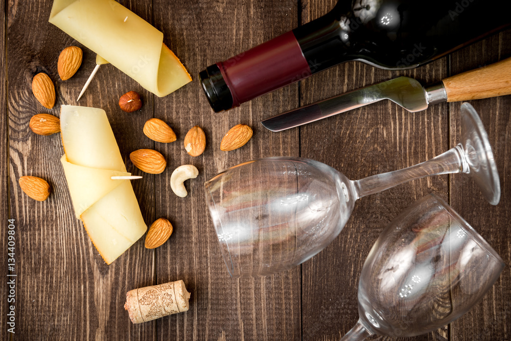 red wine with cheese on wooden background top view